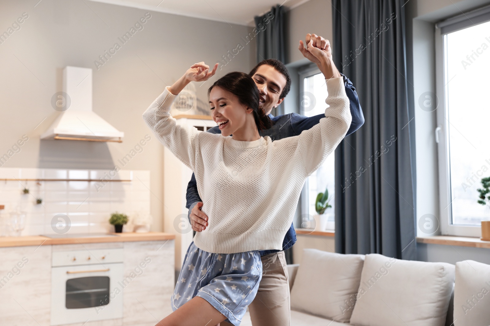 Photo of Lovely young interracial couple dancing at home