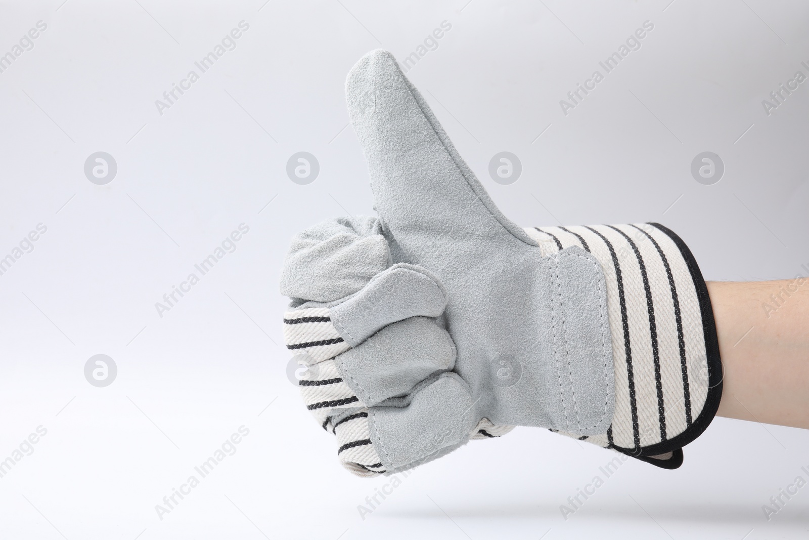 Photo of Woman in gardening glove showing thumbs up on white background, closeup. Space for text