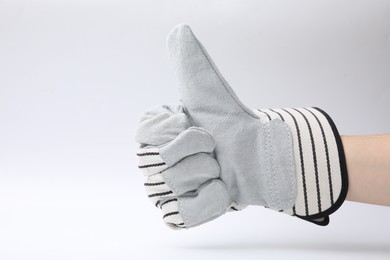 Woman in gardening glove showing thumbs up on white background, closeup. Space for text