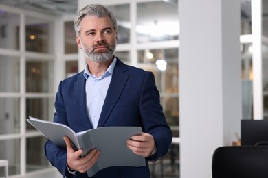 Photo of Portrait of handsome man with folder in office, space for text. Lawyer, businessman, accountant or manager