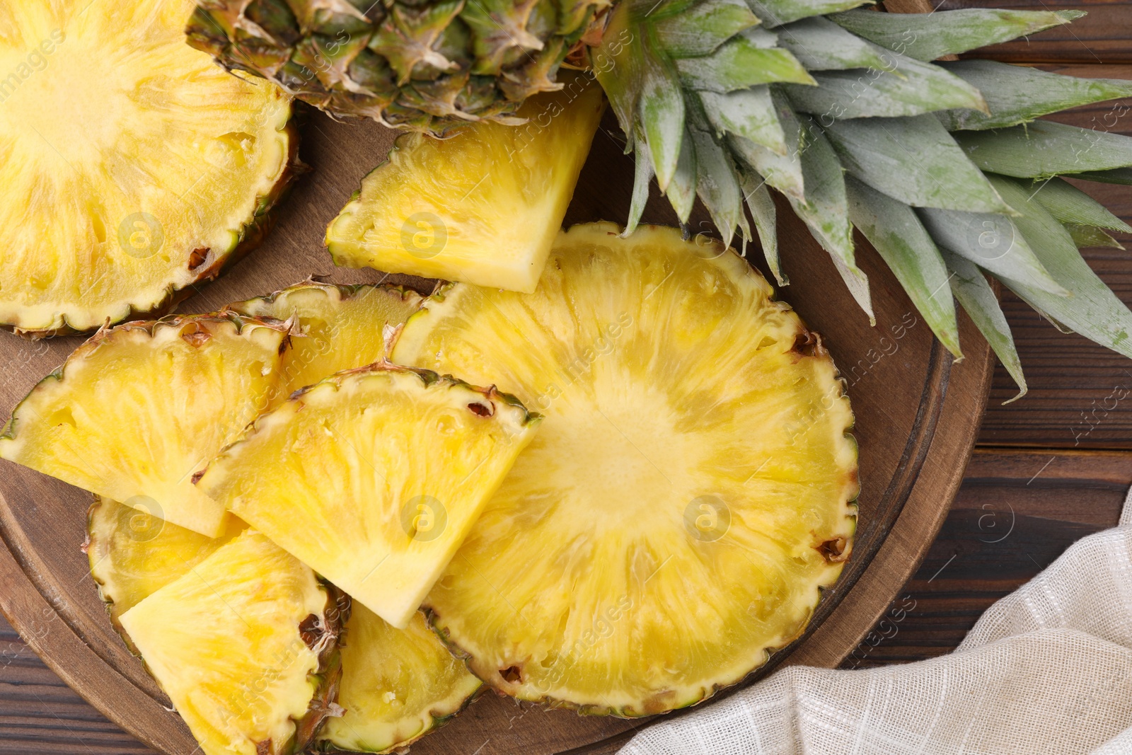 Photo of Pieces of tasty ripe pineapple on table, top view