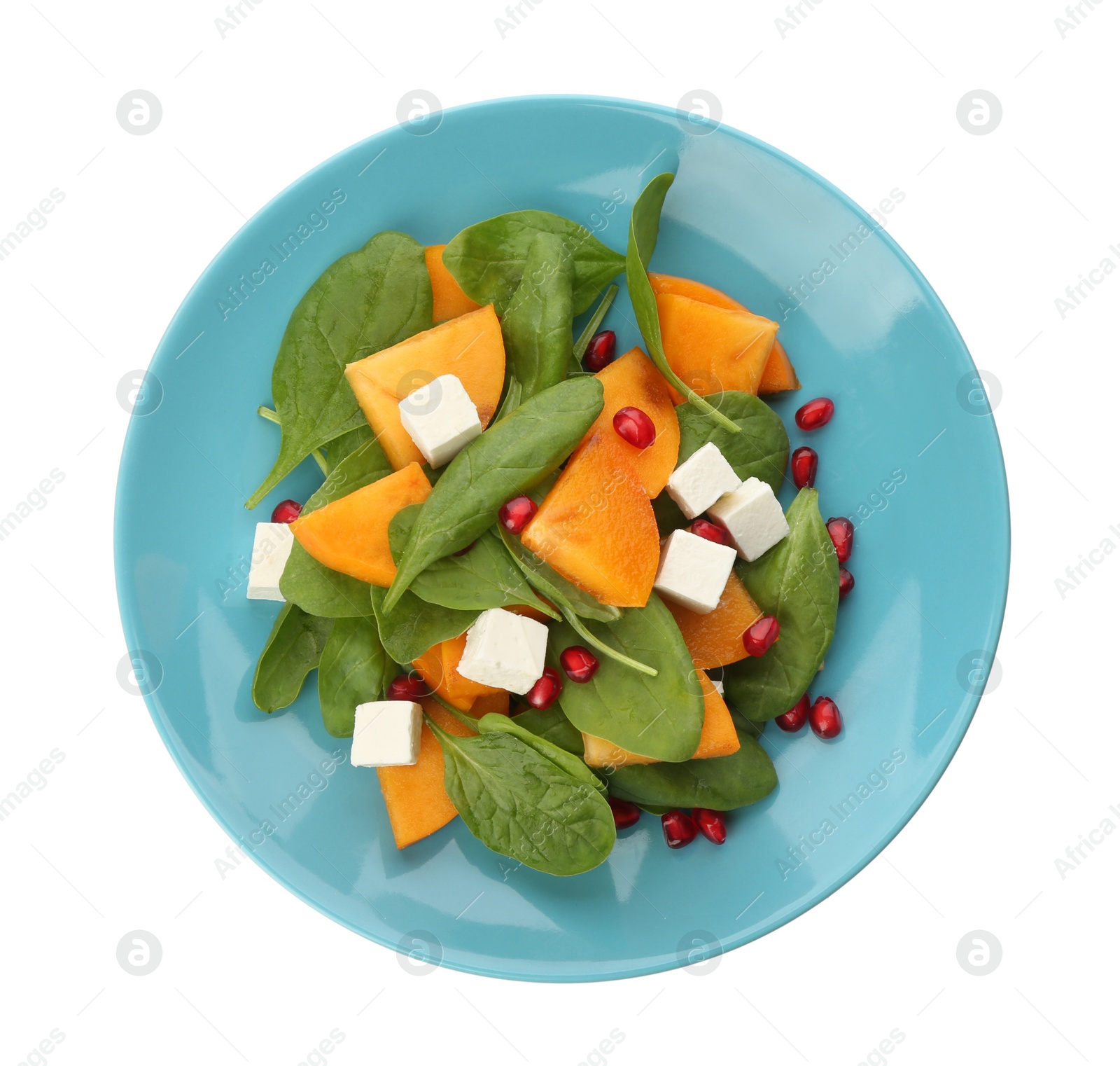 Photo of Delicious persimmon salad with pomegranate and spinach isolated on white, top view