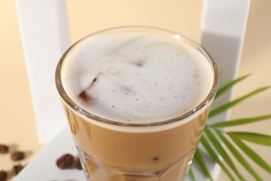 Photo of Refreshing iced coffee with milk in glass on table, closeup