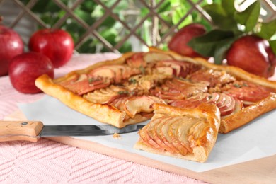 Photo of Freshly baked apple pie with knife on table, closeup