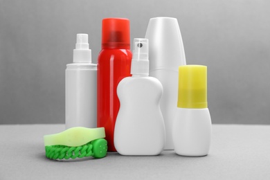 Set of different insect repellents on grey background