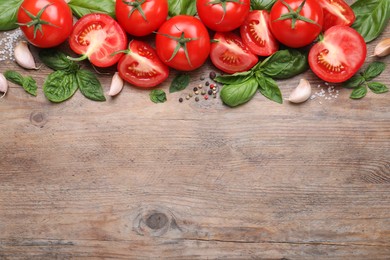 Photo of Flat lay composition with fresh green basil leaves on wooden table, space for text