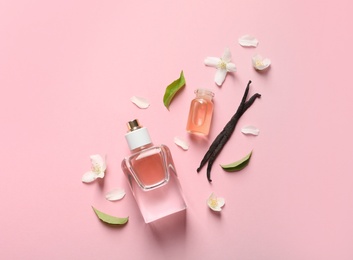 Flat lay composition with elegant perfume on pink background