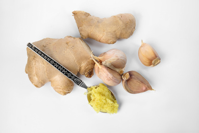 Photo of Fresh garlic and ginger isolated on white, top view. Natural cold remedies