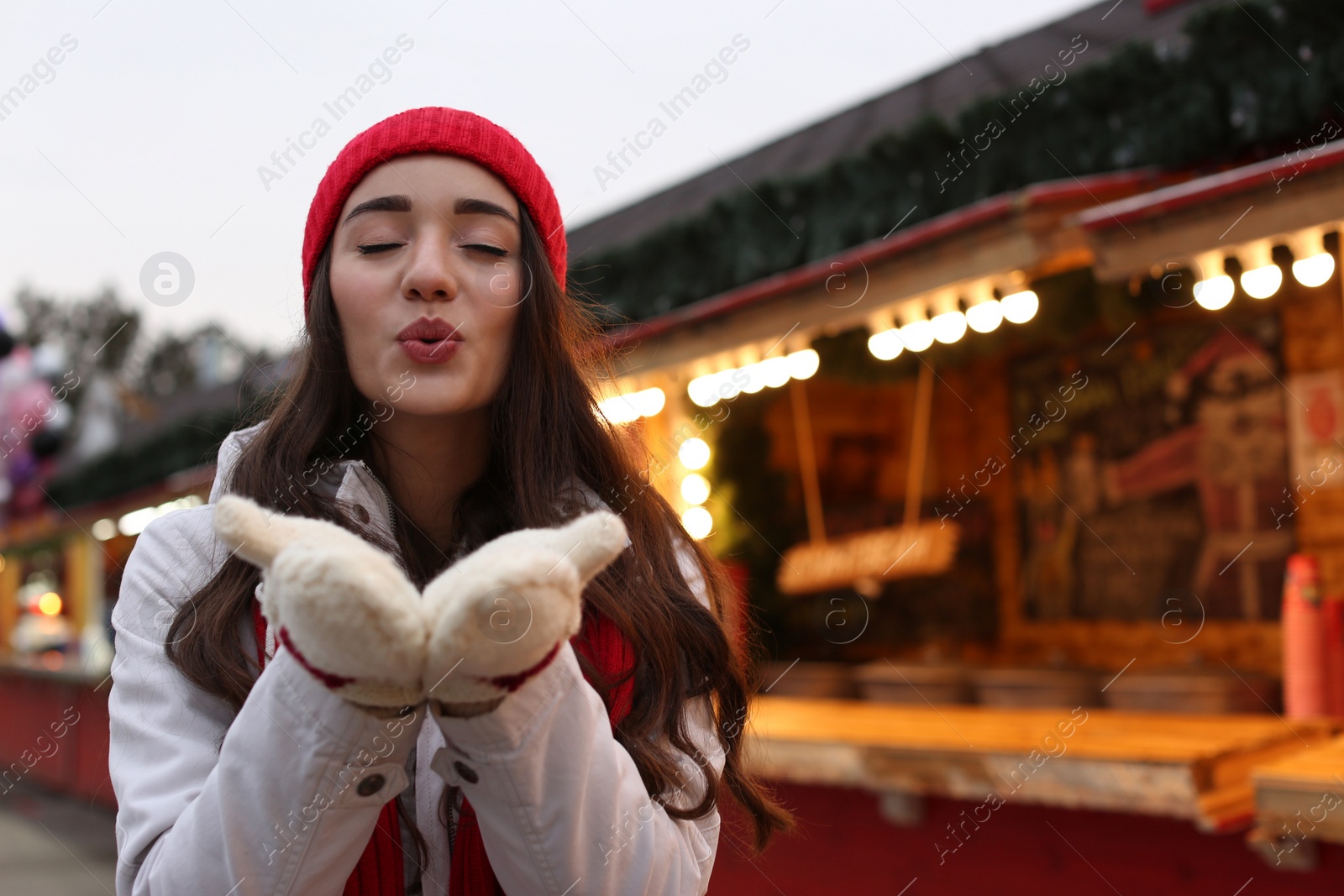 Photo of Young woman spending time at Christmas fair, space for text