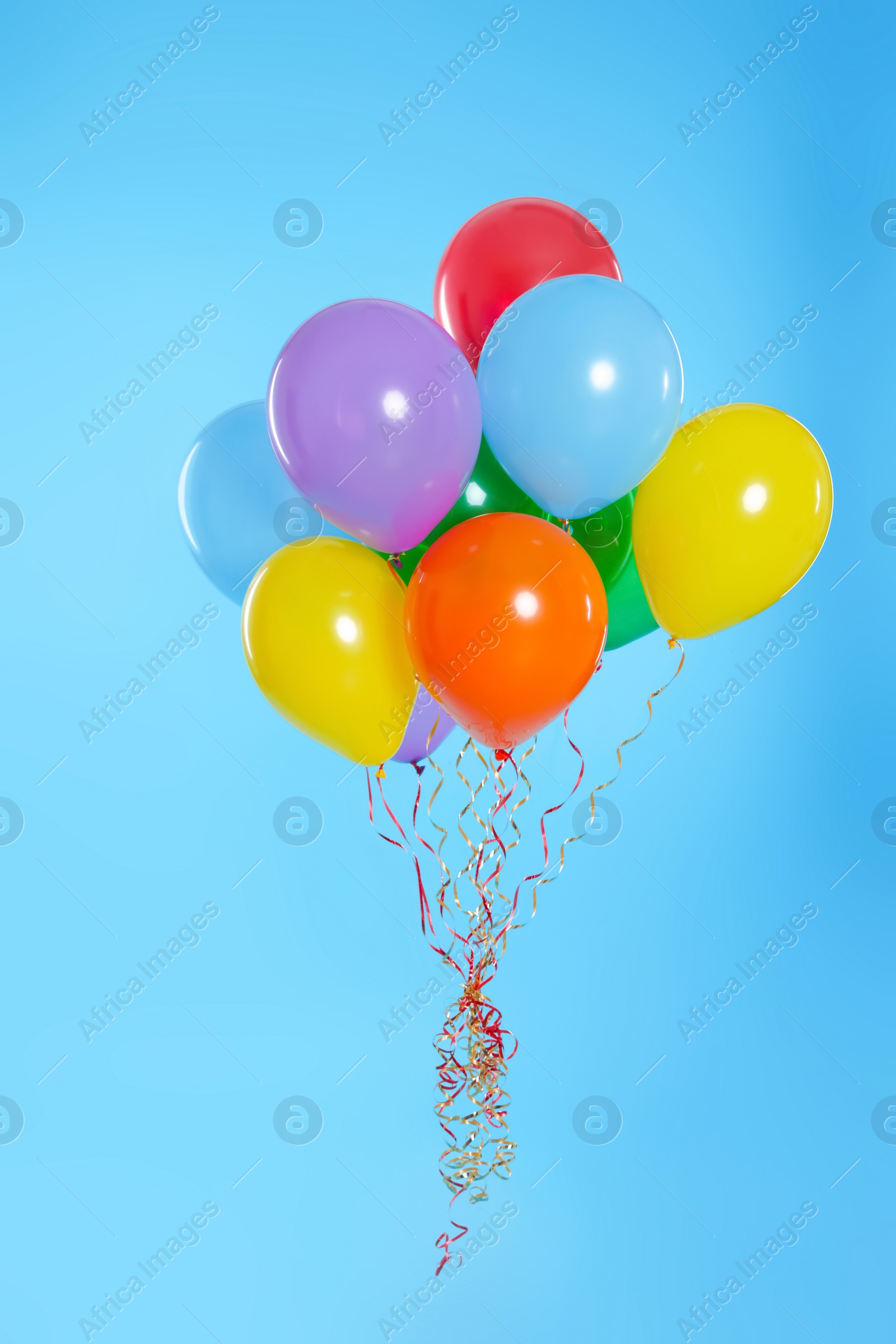 Photo of Bunch of bright balloons on color background