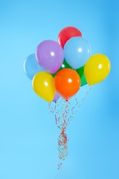 Bunch of bright balloons on color background