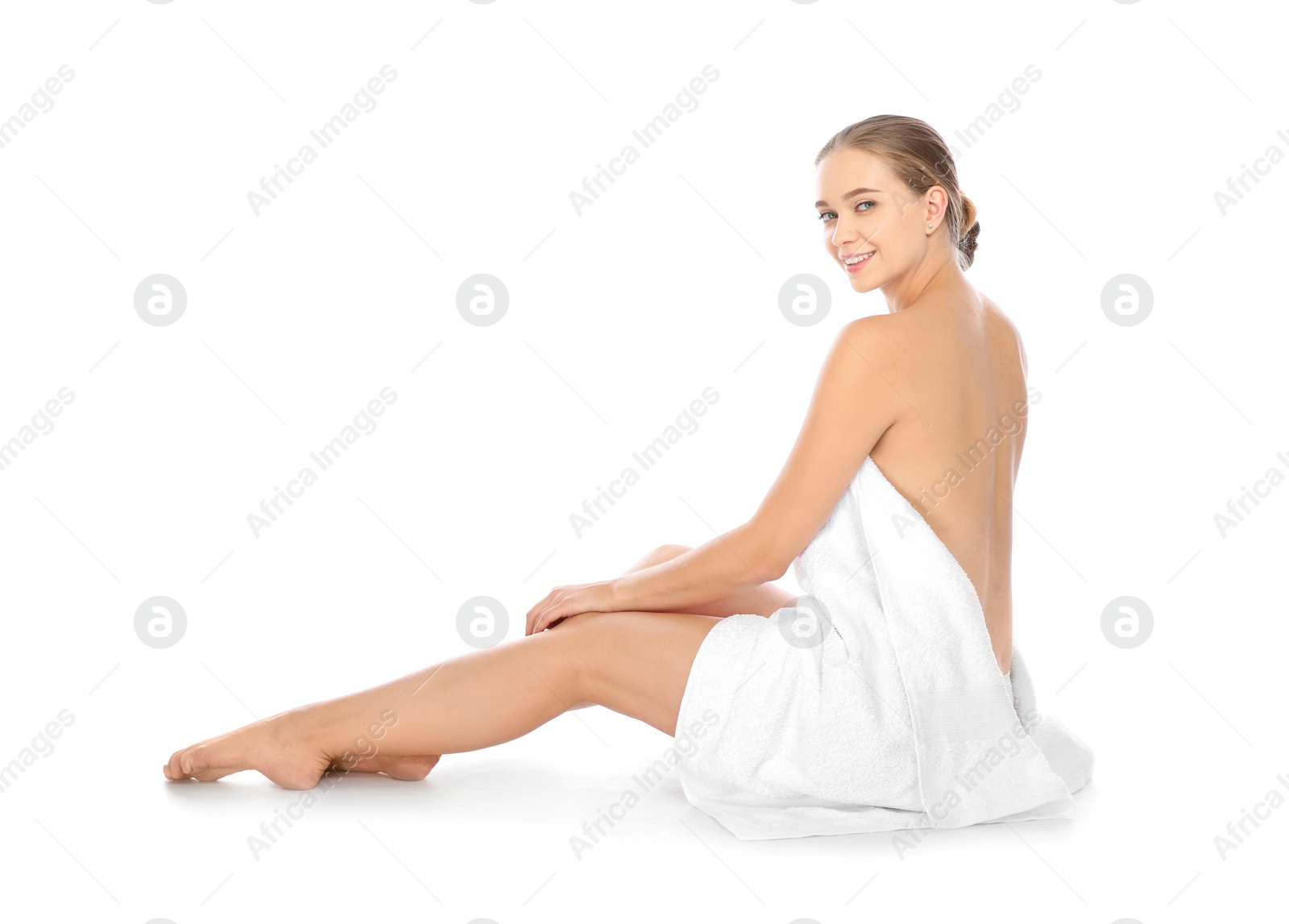 Photo of Portrait of young pretty woman with towel sitting on white background