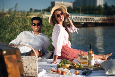 Happy couple spending time on pier at picnic