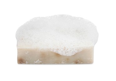 Soap bar with fluffy foam on white background