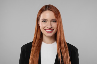 Portrait of beautiful young woman on light gray background