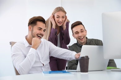 Group of colleagues laughing together in office