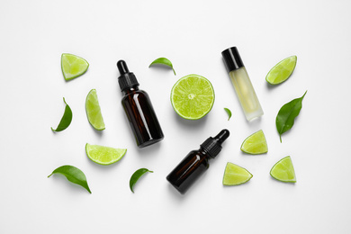 Photo of Composition with lime essential oil on white background, top view