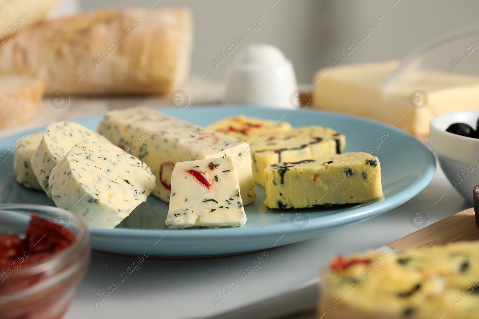 Photo of Different types of tasty butter on table, closeup