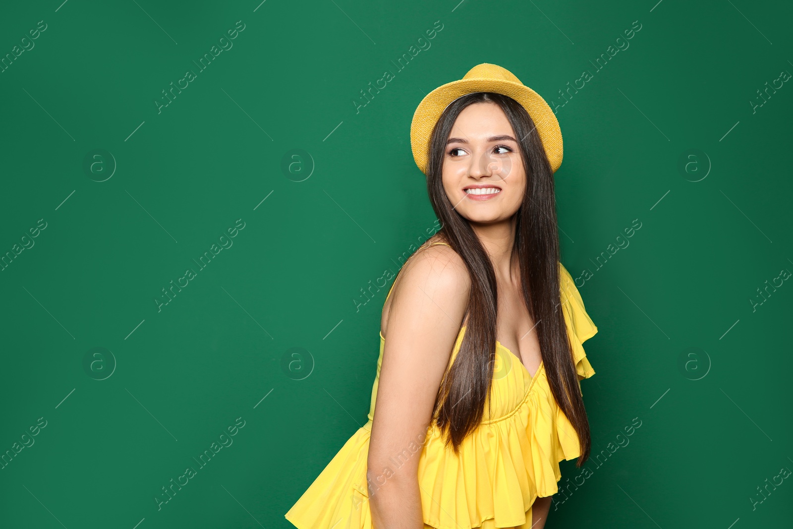 Photo of Beautiful young woman in stylish clothes on color background, space for text