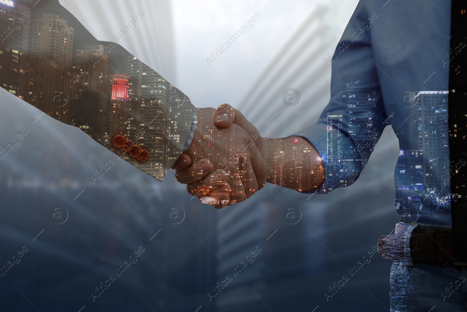 Image of Double exposure of partners shaking hands and cityscape