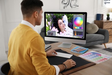 Professional retoucher working on computer in office