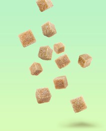 Image of Brown cane sugar cubes falling on color gradient background