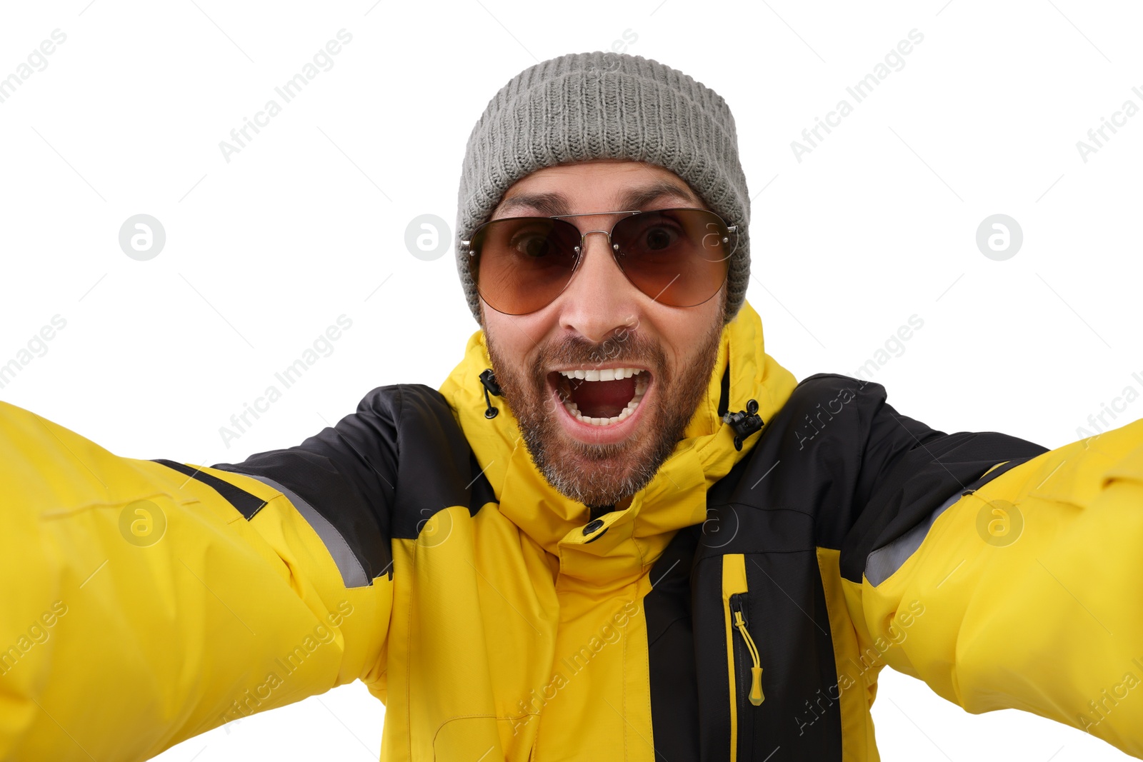 Photo of Smiling man in hat and sunglasses taking selfie on white background