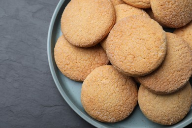 Photo of Delicious sugar cookies on black table, top view