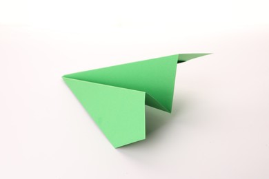 Handmade green paper plane isolated on white