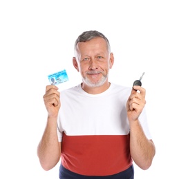 Happy mature man with driving license and car key on white background