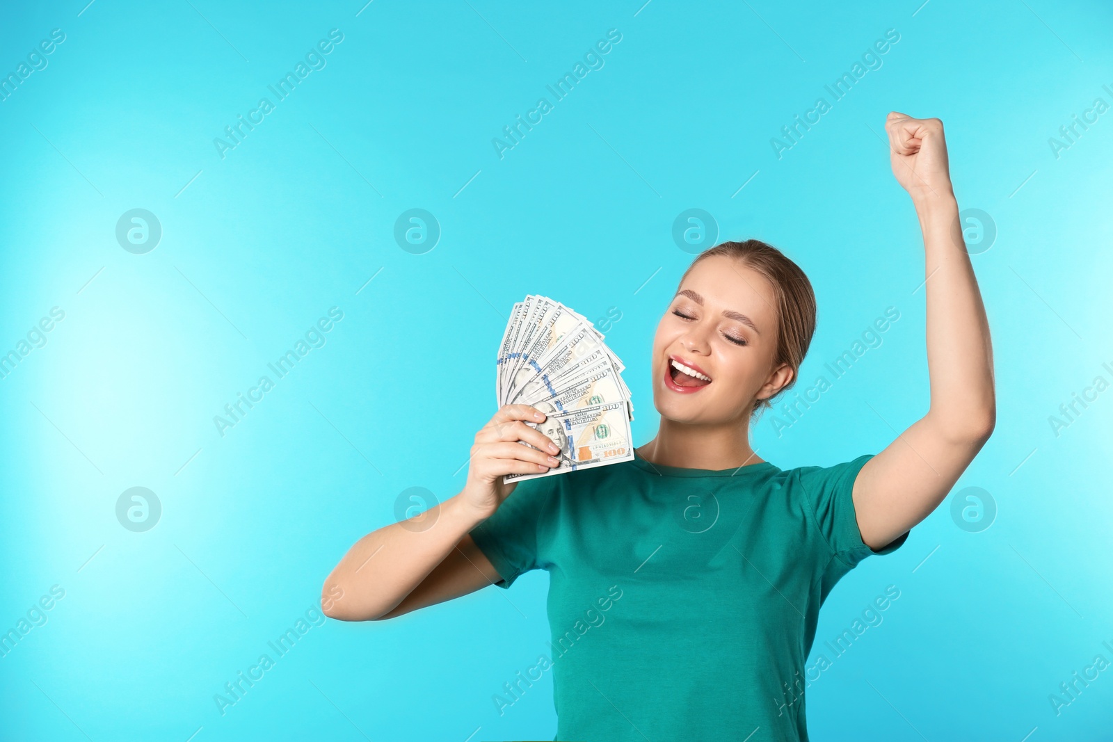 Photo of Portrait of happy young woman with money on color background. Space for text