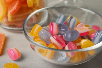 Tasty colorful sweets on light grey table, closeup