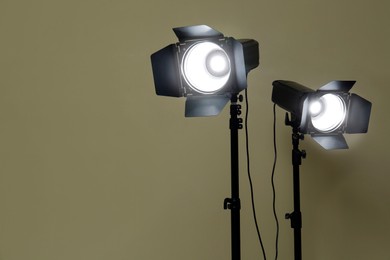 Photo of Modern spotlights against beige background, space for text