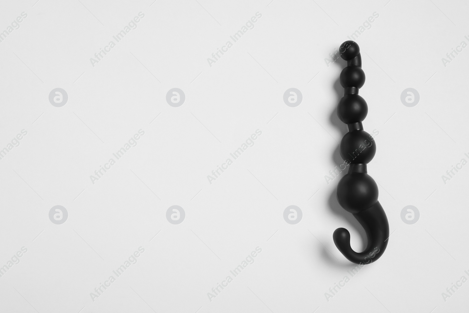 Photo of Black anal beads on white background, top view. Sex toy