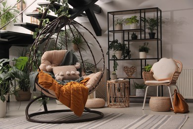 Indoor terrace interior with hanging chair and green plants