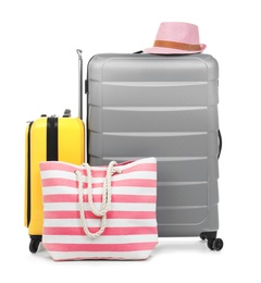 Photo of New suitcases and bag packed for journey on white background