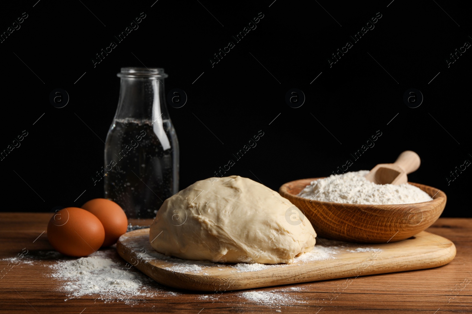 Photo of Cooking scones with soda water. Dough and ingredients on wooden table