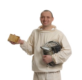 Photo of Beekeeper in uniform holding smokepot and hive frame with honeycomb on white background