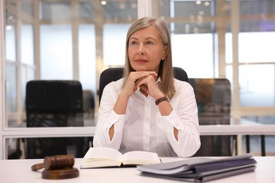Photo of Portrait of confident lawyer working at table in office