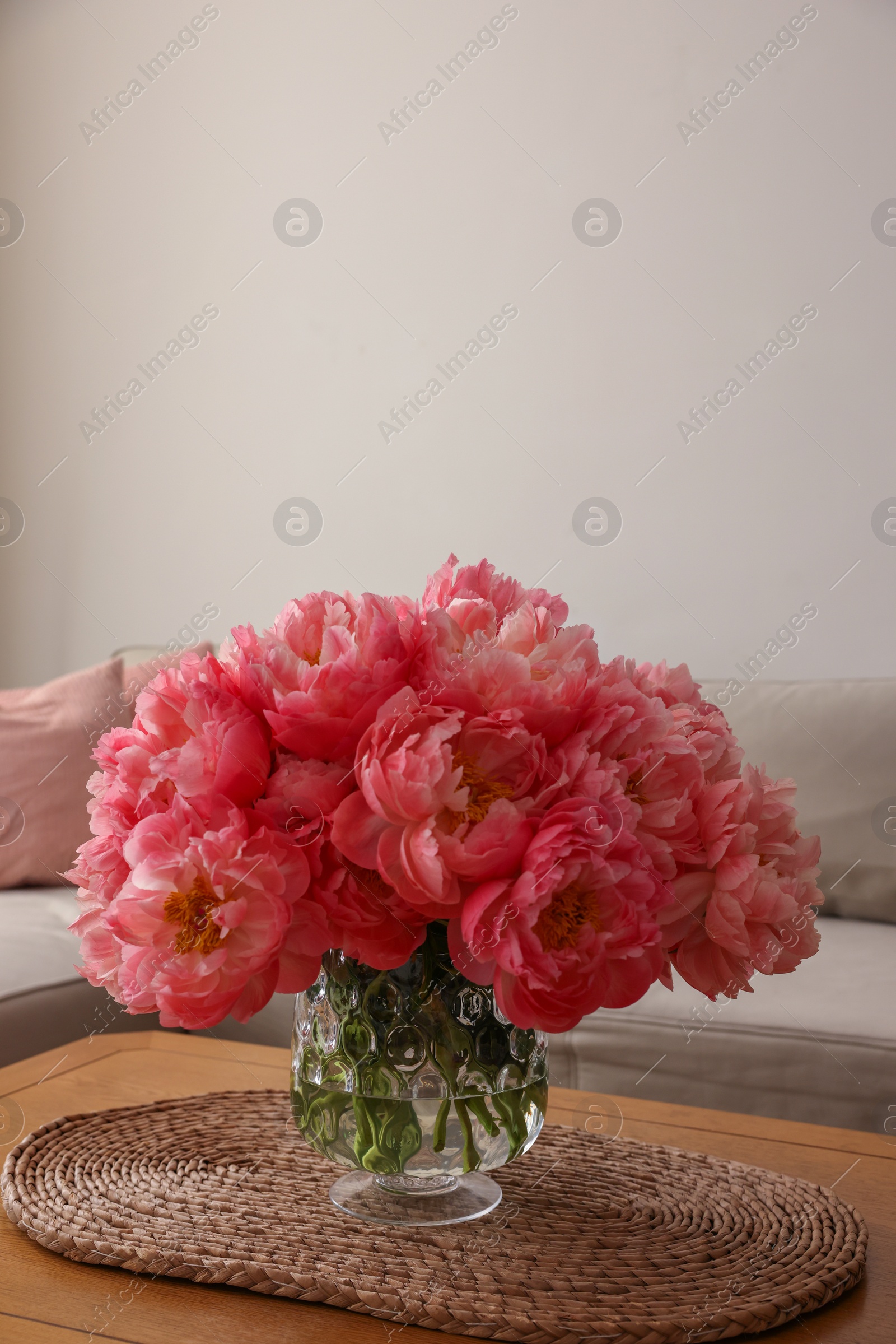 Photo of Beautiful pink peonies in vase on table at home, space for text. Interior design