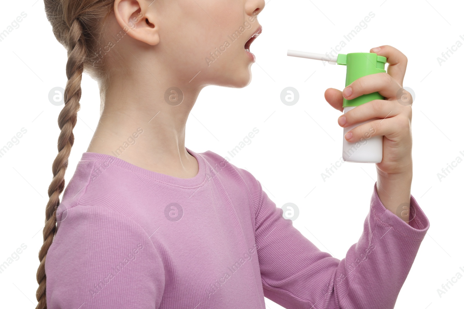 Photo of Little girl using throat spray on white background, closeup