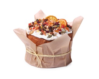 Traditional Easter cake with sprinkles and dried fruits in parchment paper isolated on white