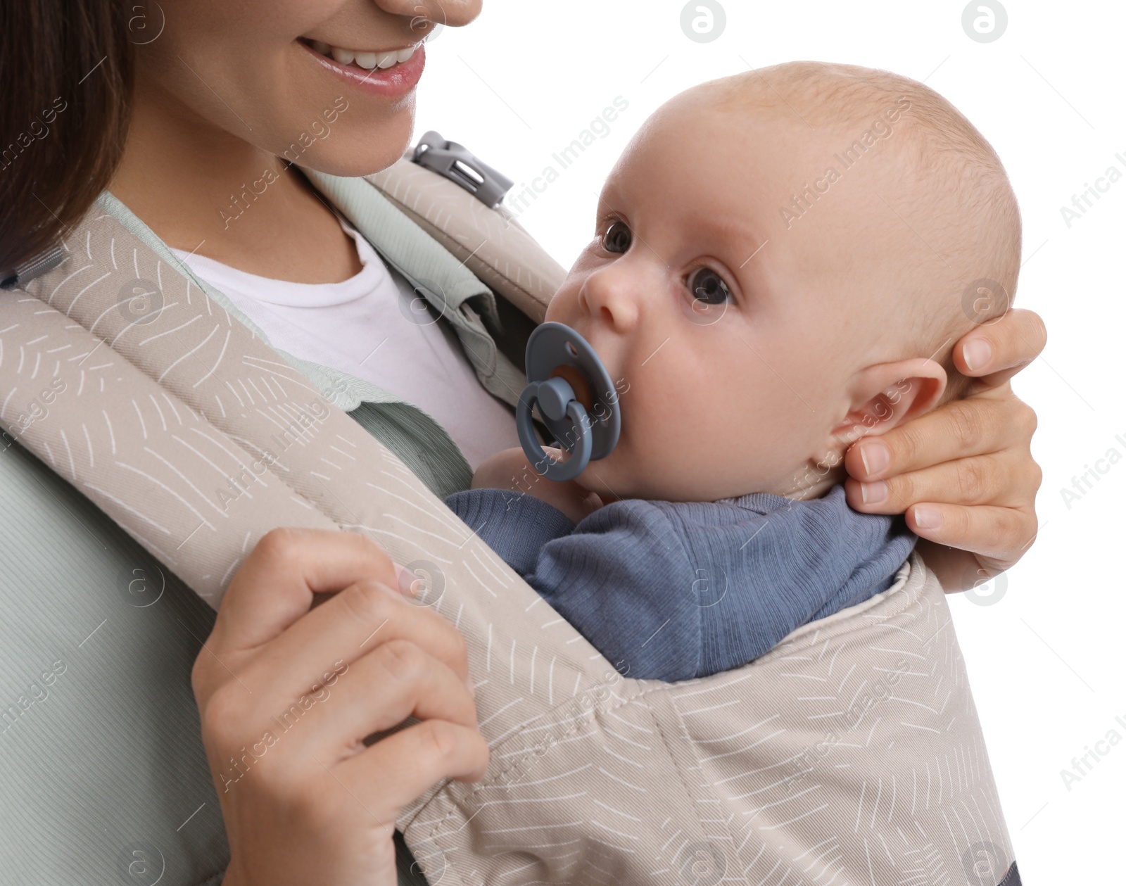 Photo of Mother holding her child in baby carrier on white background, closeup