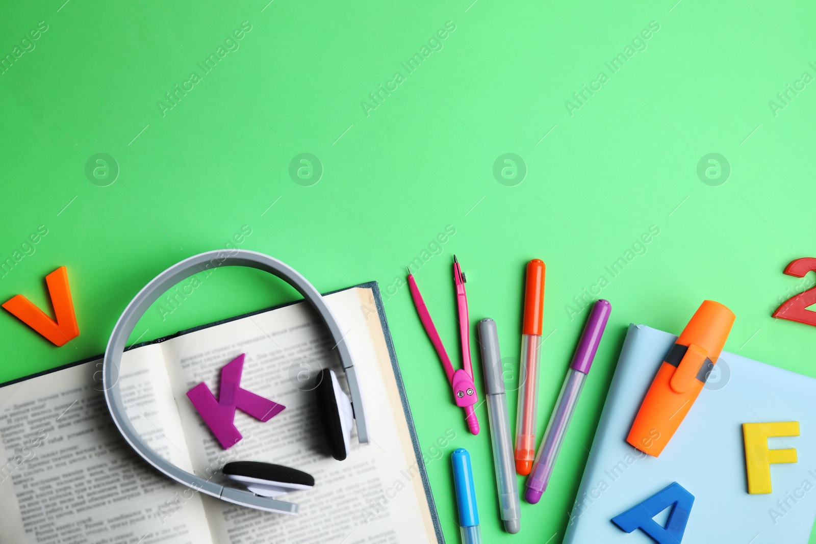 Photo of Flat lay composition with books and stationery on light  green background. Space for text