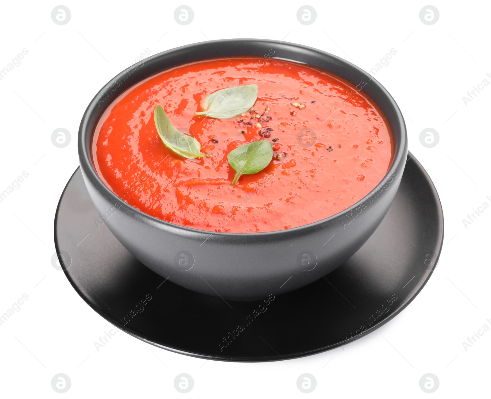 Photo of Bowl of delicious tomato cream soup isolated on white