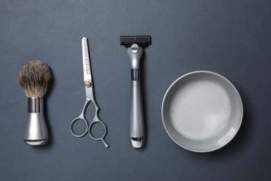 Photo of Set of men's shaving tools on dark grey background, flat lay