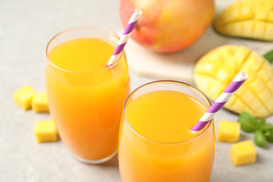 Photo of Fresh delicious mango drink on light table