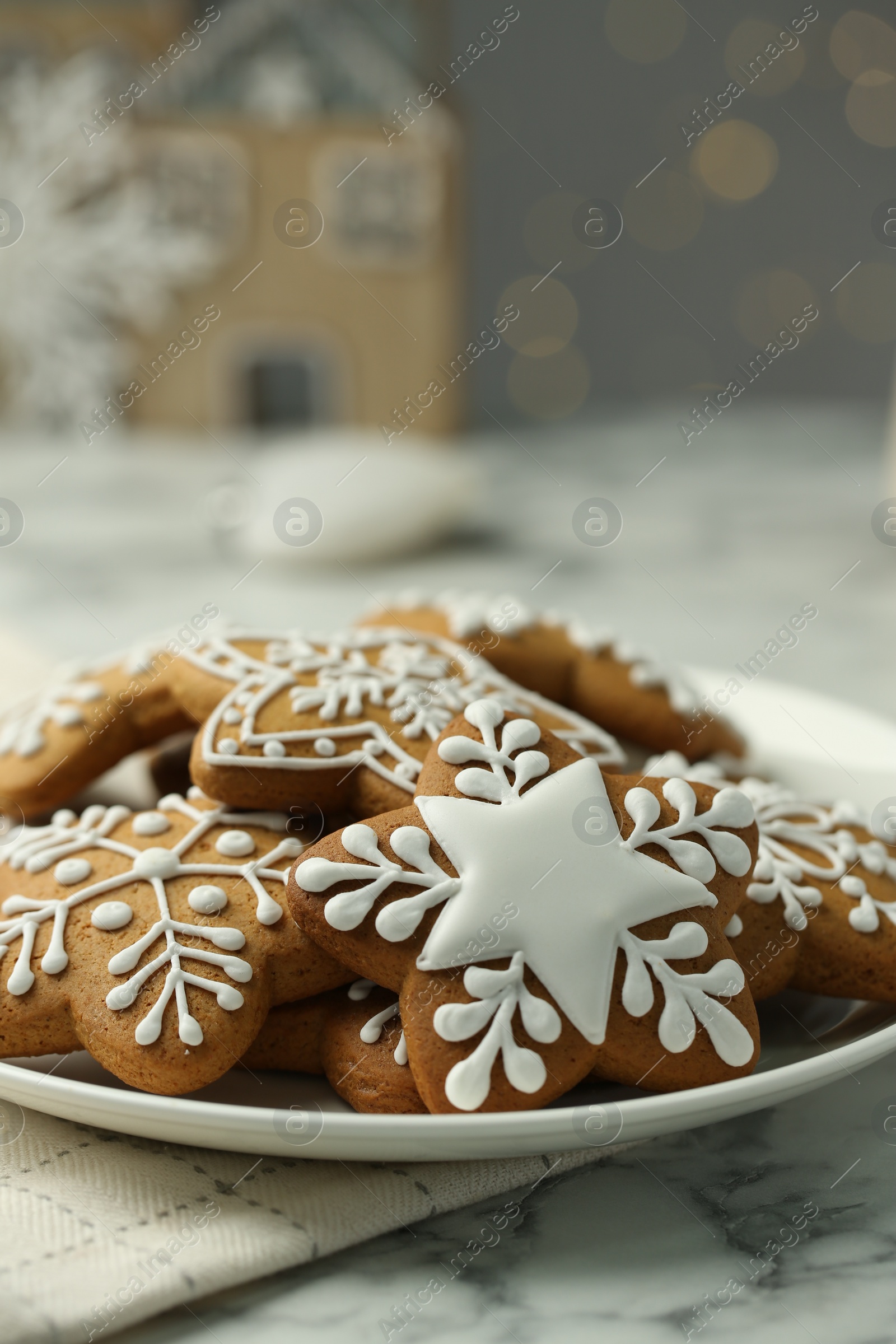 Photo of Tasty Christmas cookies with icing on white marble table, closeup