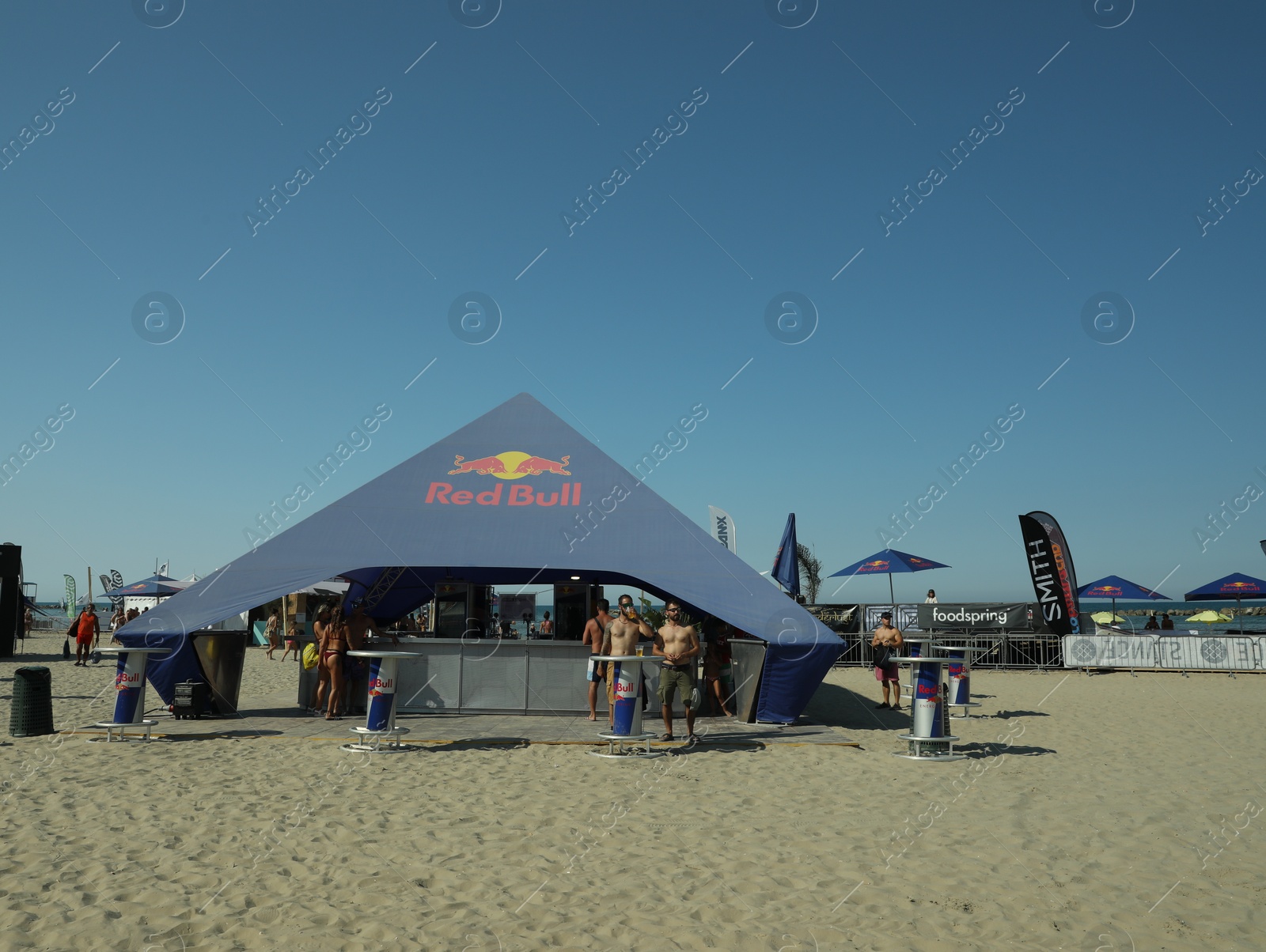 Photo of SENIGALLIA, ITALY - JULY 22, 2022: Red Bull tent on beach under blue sky