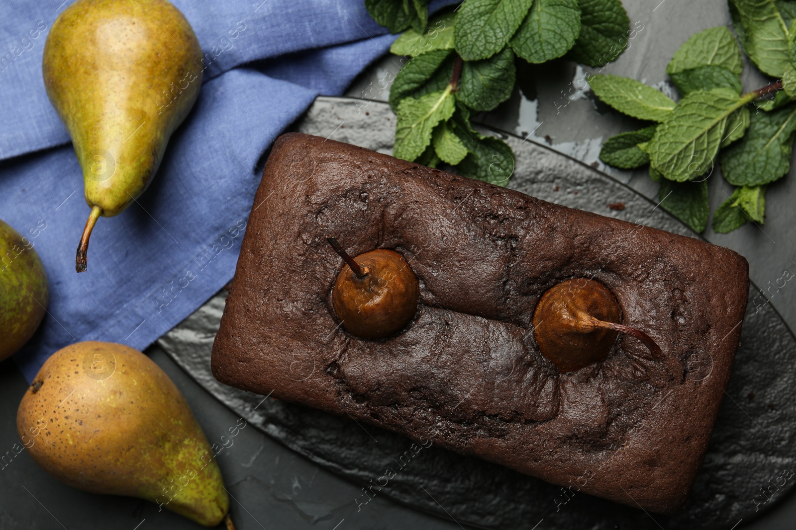 Photo of Flat lay composition with tasty pear bread on black table. Homemade cake